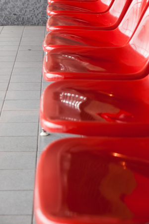 The row of red chairs in the airport
