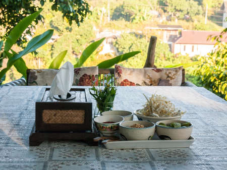 Pad Thai ingredient such as lemon, pepper, sugar, crushed peanuts, bean sprouts and put on a tablecloth pattern cute.の写真素材