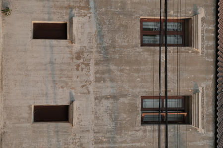 Old wooden windows of old buildings. And there are walls that fall apart and deteriorate.の写真素材