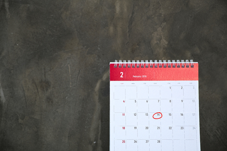 February Calendar, which is only 28 days. And day 14th is a day of love(Valentines day) on the white table and cement wall background.の写真素材