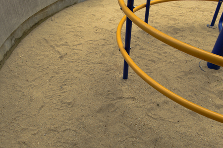 Sand in the playground and yellow and blue equipment for children's climbing, .の写真素材