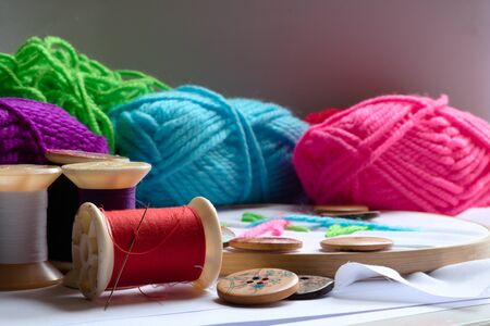 Embroidery accessories for a variety of colors, such as yarn, needle and buttons brought together...