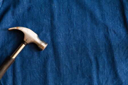 The stainless hammer place on a blue denim