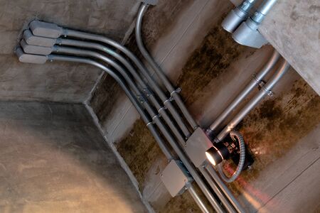 Electrical wiring work in a steel pipe of a house with a loft style decoration design.の写真素材