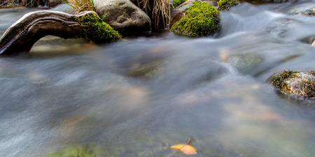 Water flowing smoothly down a stream.の写真素材