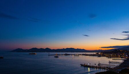Sunset over the port of Cannes, France.の写真素材