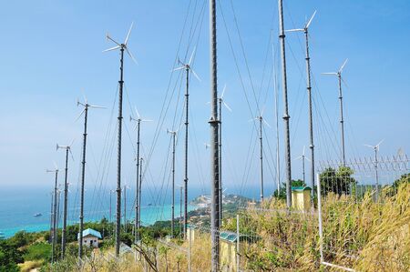 Wind turbine generating electricity on blue sky