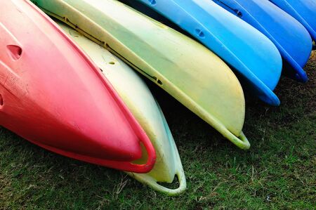 Colorful kayaks in stackの写真素材