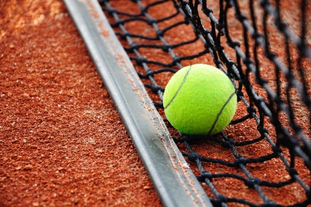 Tennis ball on a tennis clay courtの写真素材