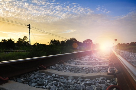 railroad to horizon under cloudy skyの写真素材