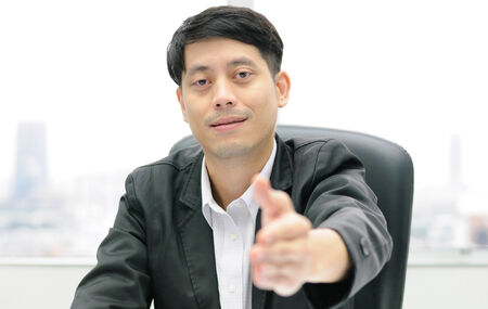 A business man with an open hand ready to seal a dealの写真素材