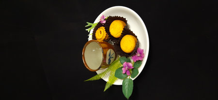 Coffee cup and cookie and flowers on a on a white plateの写真素材