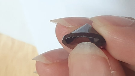 Examination of garnet gemstones treated by scraping off the plastic coatingの写真素材