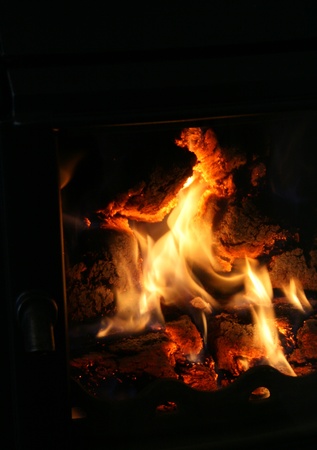 fire flames in black chimney frameの写真素材