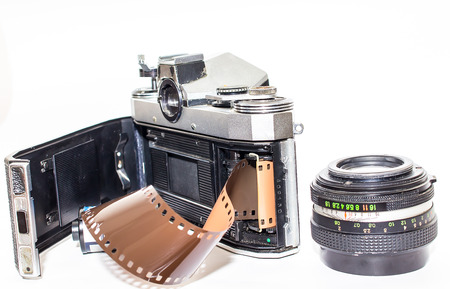 isolated retro  photograph camera with film and lens