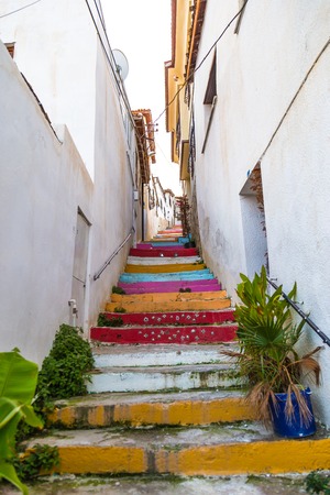 Colorful stairs to the sky among the old buildings