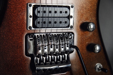 Electric guitar detail view, zoom in to floyd rose, very shallow depth of field image, cinematic effect appliedの写真素材