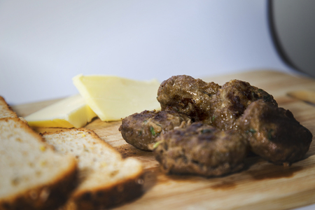 Homemade diet hamburger over wooden flat, yellow filter appliedの写真素材
