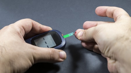 checking blood glucose for treatment studio image