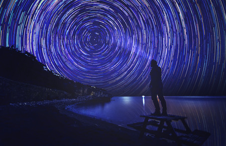 anonymous man enlight the trail of star which shows us to rotation of worldの写真素材