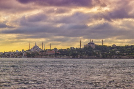 Blue Mosque and Hagia Sophia view from Halic at cloudy day, yellow effect appliedの写真素材