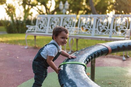 Toddler playing in playpen during sunset with warm colorsの写真素材
