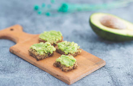 close up detail view of avocado bread bites over rustic backdropの写真素材