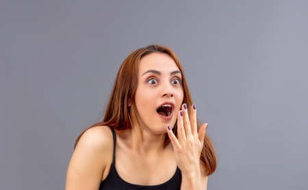 Beautiful Turkish shocked and surprised woman in a studioの写真素材