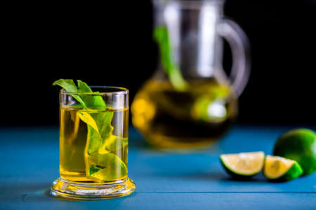 Closeup green tea view with lime and carafe studio shot