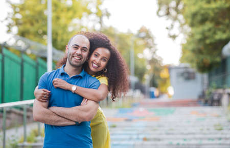 White man and Black curly Afro woman are having a great time, they are laughing and looking each other.の写真素材
