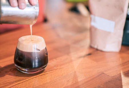 Barista is prepring a cold brew in a vintage designed coffee shop. Closeup detail view with...
