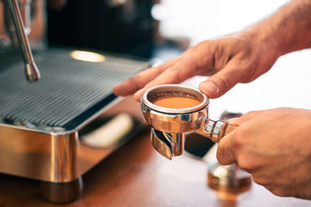 Tampered coffee beans view in a portafilter from an elegant coffee shop, includes copy space.の写真素材