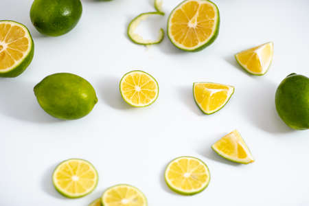 Flat lay view green lime lemons over isolated white backdrop.Includes copy space.の写真素材