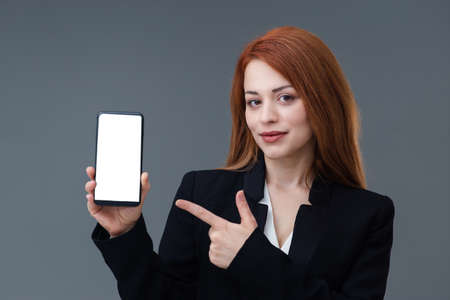 Beautiful smiling Turkish young woman, mobile phone concept. She is checking her mobile phone.の写真素材