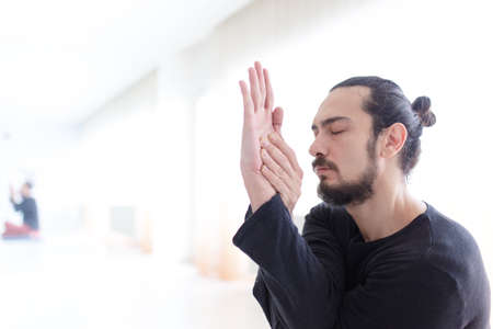 Man in peace with calm mood in meditation trance. Includes copy space, interior shot with...