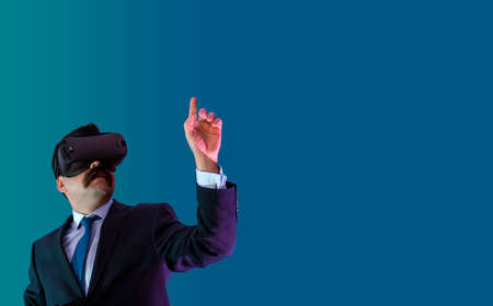 Businessman in suit dresscode, experience virtual reality with hologram concept. Includes copy...