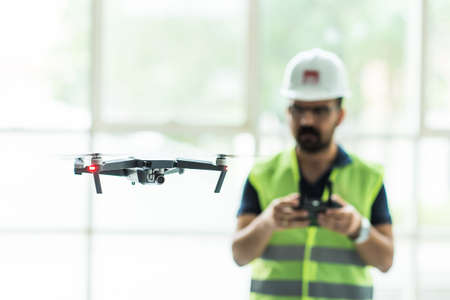 UAV pilots view with protective helmet and yellow vest for industrial videography.