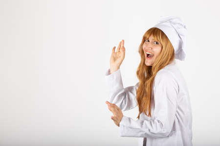 Beautiful smiling woman chef portrait in studio with okay gesture includes copy spaceの写真素材