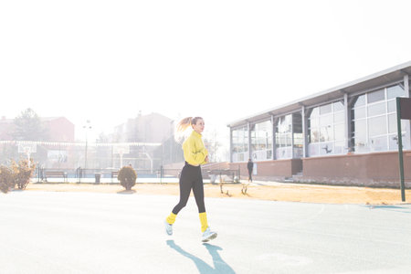 young beautiful hipster woman jogging in the city, lifestyle people conceptの写真素材