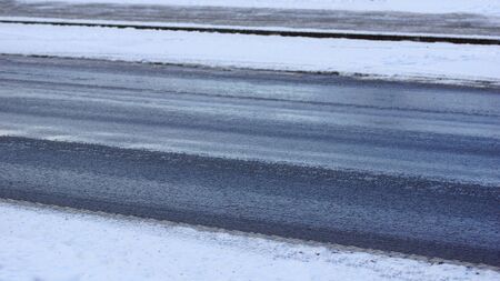 ice and snow on the road - winter - accident hazardの写真素材