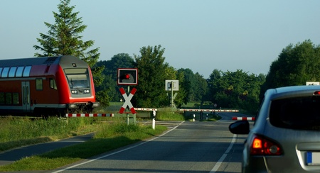 red railroad crossing a country road - down barrierの写真素材