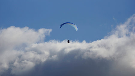 Paragliding over the cloudsの写真素材