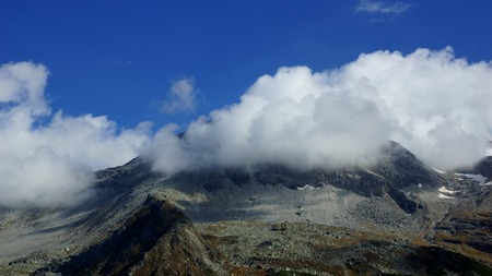 beautiful white clouds of the Alps and summerの写真素材