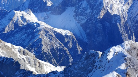 snow and rocks and summit of the mountainsの写真素材