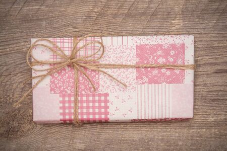 Pink gift box on wooden background with copy spaceの写真素材
