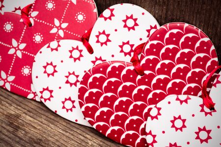 Valentines Day background, red and white hearts on wooden background. Selective focus, tonedの写真素材