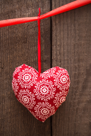 Valentines day background with handmade toy heart on wooden background. Selective focus, tonedの写真素材
