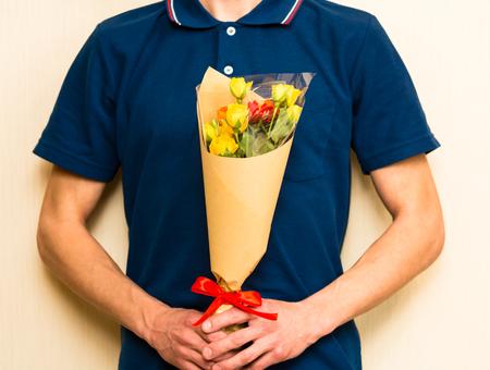 Man holding bouquet of yellow and orange roses. Women' s day, Valentines Day, Mothers day. Selective focusの写真素材