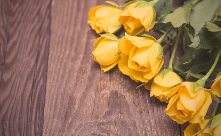 Yellow roses on a wooden background. Women' s day, Valentines Day, Mothers day. Copy space, selective focus, tonedの写真素材