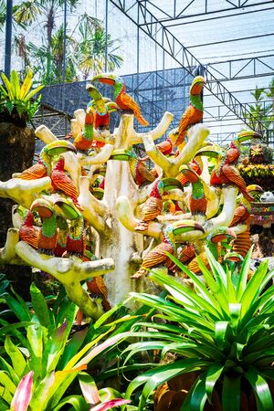CHONBURI, THAILAND - March 18, 2016: Beautiful garden decoration in Nong Nooch Tropical Botanical Garden. Many parrots. Nong Nooch Tropical Botanical Garden is a 500-acre botanical garden in Chonburi, Thailand.のeditorial素材